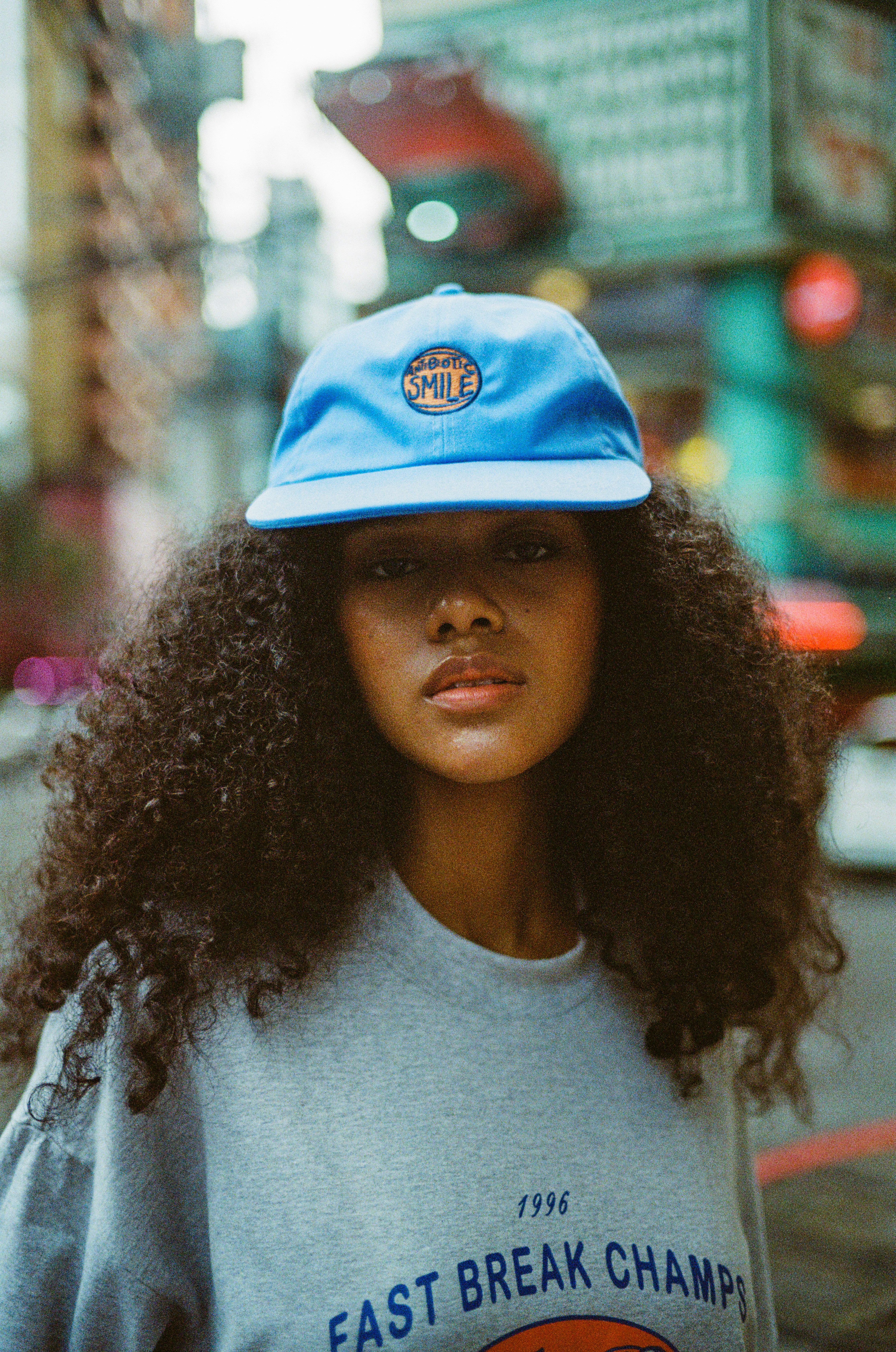 Night city portrait in cap and vintage sweatshirt